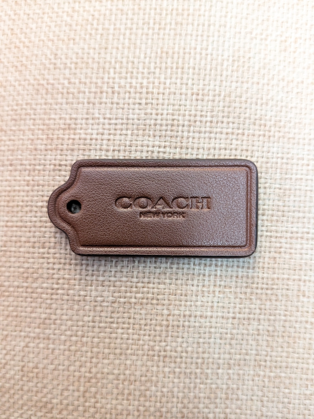Coach brown leather hang tag